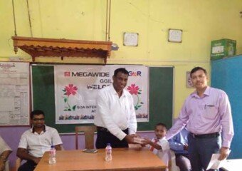 Student Receiving Study Material from the hands of Sarpanch - Mr.PradipKambli